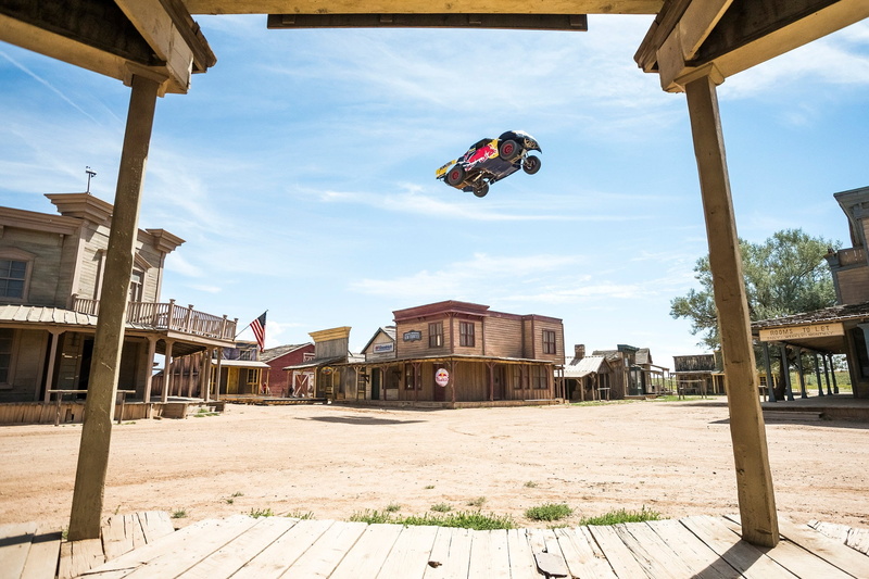 Ghost town, hanging, city, wood - material, trucks, day, cloud - sky, architecture, town, flying, built structure, mid-air, sky, Red Bull, building, building exterior