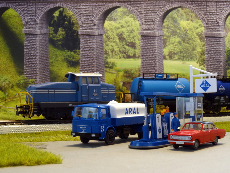 travel, 70 years, motion, public transportation, outdoors, railway, diorama, road, tree, land vehicle, architecture, motor vehicle, day, built structure
