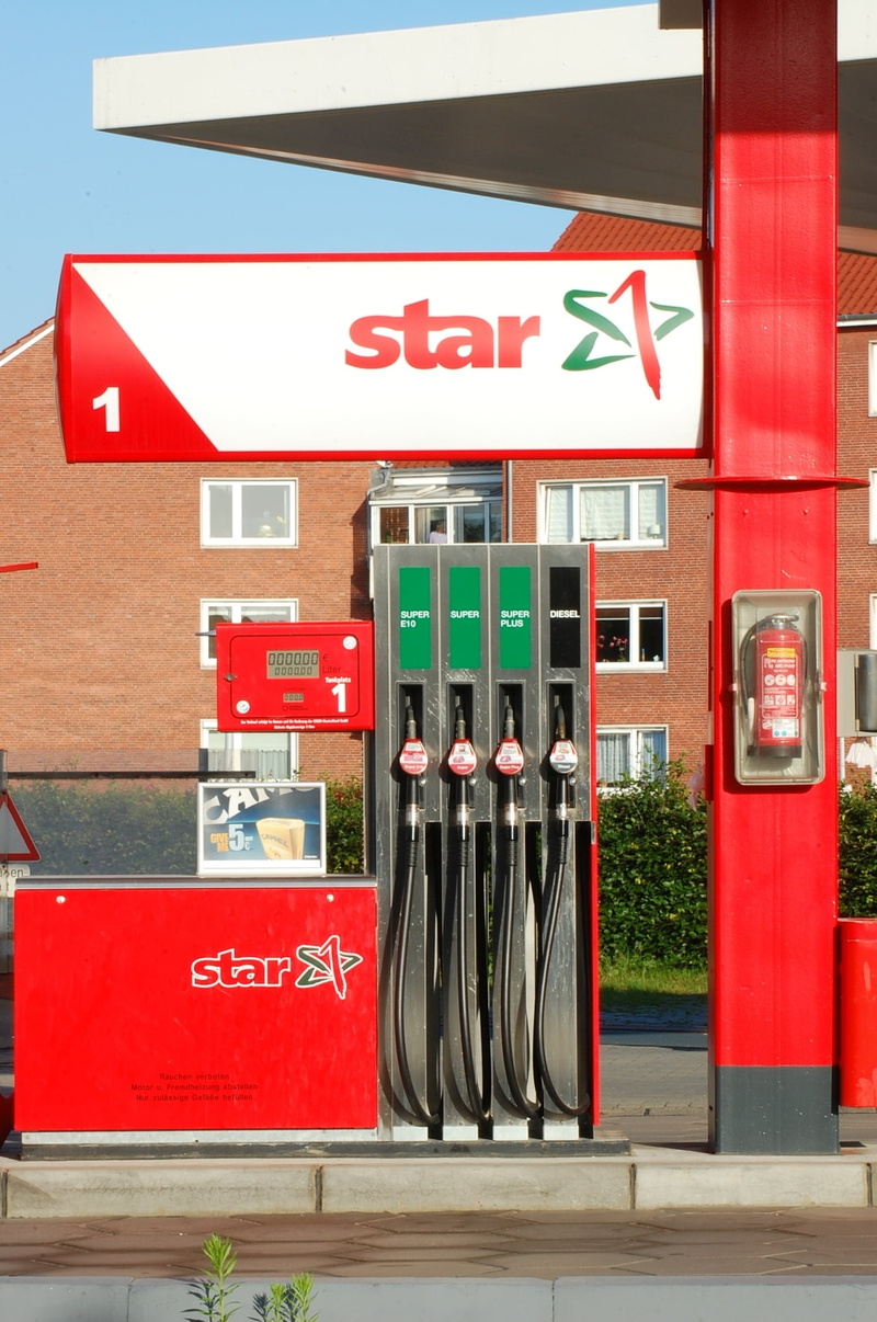 telephone booth, text, western script, building exterior, day, petrol stations, sign, traffic, transportation, energy, outdoors, fossil fuel, fuel pump