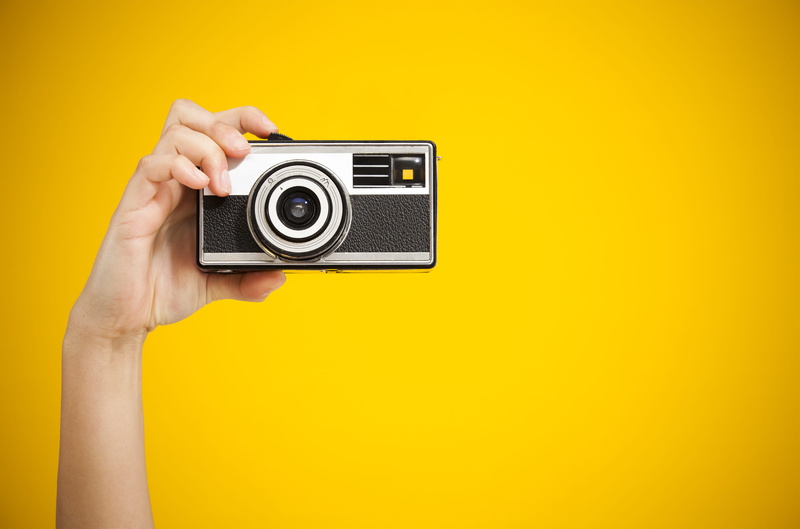 camera, camera - photographic equipment, g, digital camera, person, retro styled, human hand, hand, copy space, yellow background, e, black, human body part