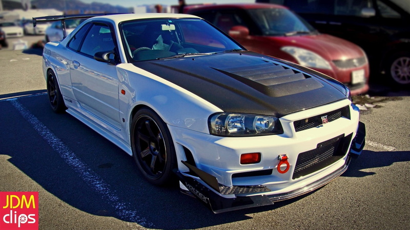 no people, Nissan Skyline GT-R R34 V-Spec II, city, luxury, road, blue, land vehicle, sign, car, day, close-up, stationary, retail, JDM, focus on foreground