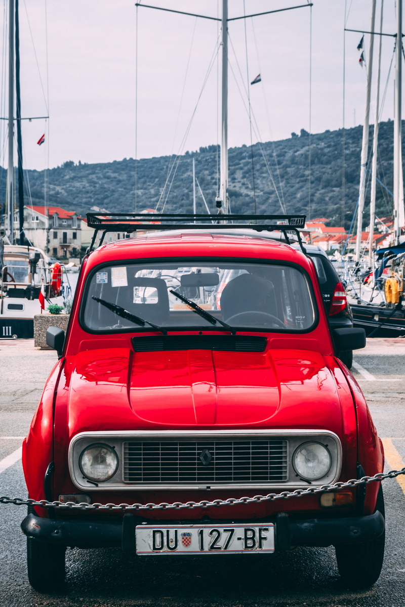 car, automobile, road, transportation system, transportation, communication, sign, vehicle, day, Renault, no people, land vehicle, western script, nature