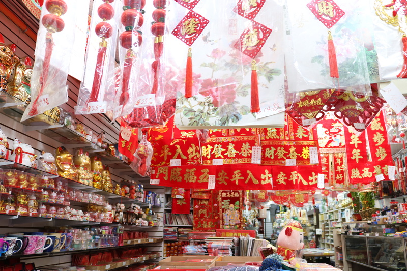 display, shelf, sweets, red, shopping, retail display, chinese, hanging, candy, sale, 5K, small business, philadelphia, script, text, choice, large group of objects