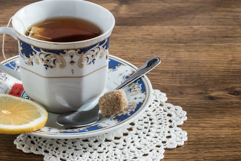 saucer, tea, no people, lemon, relaxation, refreshment, black tea, tea cup, teacup, spoon, white, wood - Material, sugar cube, food, freshness, heat - Temperature