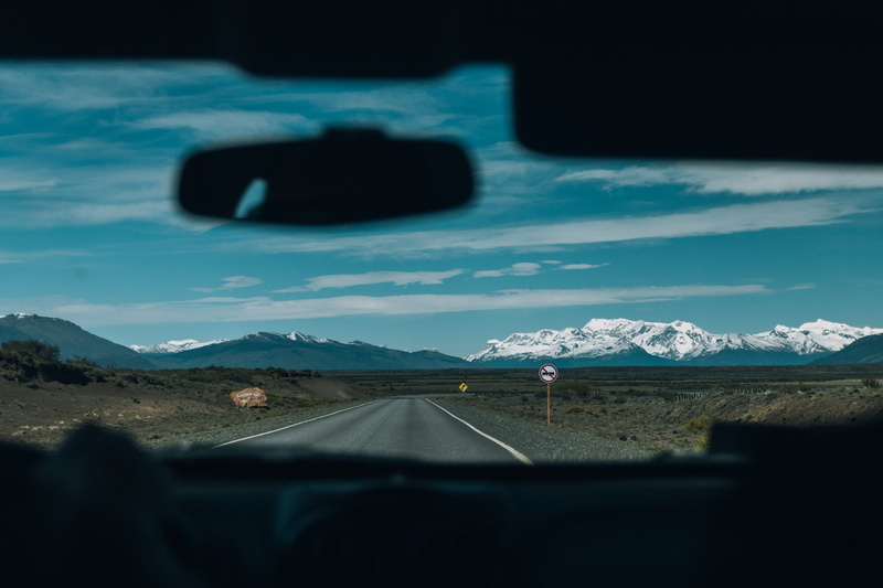 mountain, windshield, car, cloud - sky, landscape, motor vehicle, vehicle interior, direction, nature, mode of transportation, photo, covered, environment