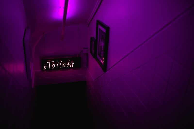 accidents and disasters, club, toilet, neon, toilets, western script, exit sign, sign, leaving, purple, communication, door, downstairs, architecture, no people