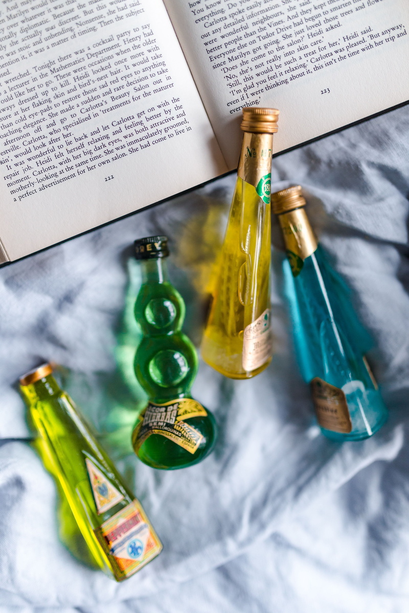 still life, studying, western script, table, green color, alcoholism, read, container, publication, book, reader, directly above, 5K, liqueurs, group of objects
