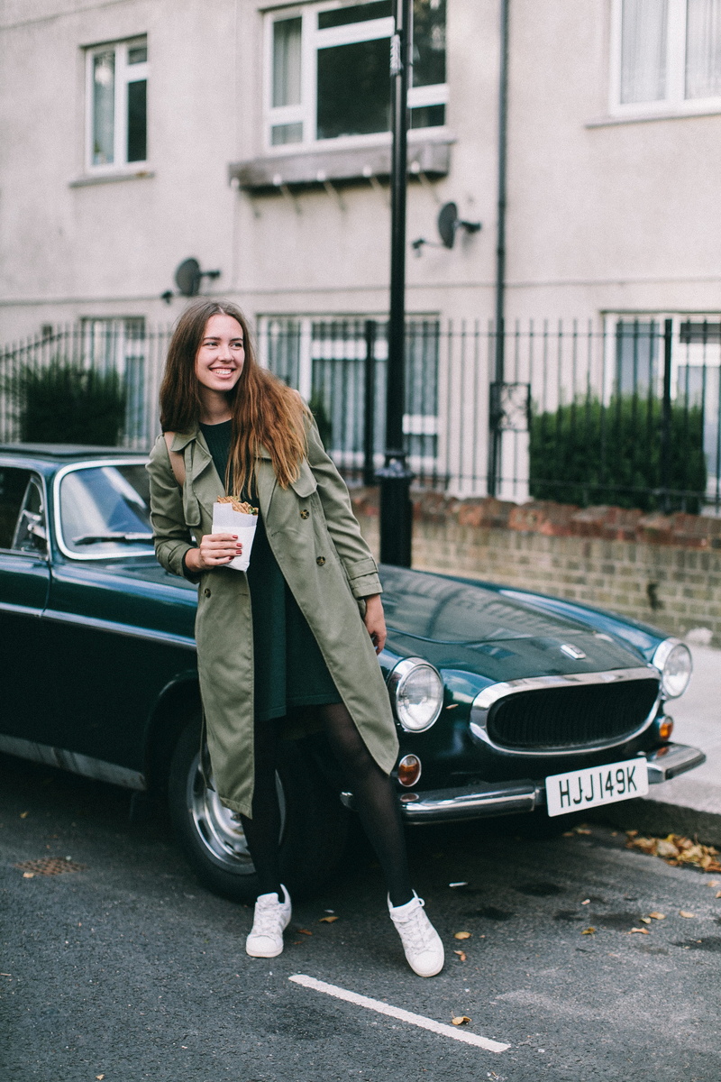 building exterior, outdoors, coupe, young women, road, parked, hairstyle, real people, wear, motor vehicle, front view, smiling, beside, automotive, vehicle