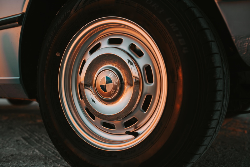 shape, photo, street, land vehicle, day, circle, metal, pattern, spoke, chrome, rubber, mode of transportation, motor vehicle, bmw, vehicle part, car wheel