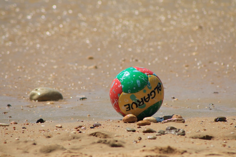sphere, algarve, sunlight, shell, outdoors, beach football, communication, pebble, colored ball, water, holidays, green color, text, summer, beach, 5K