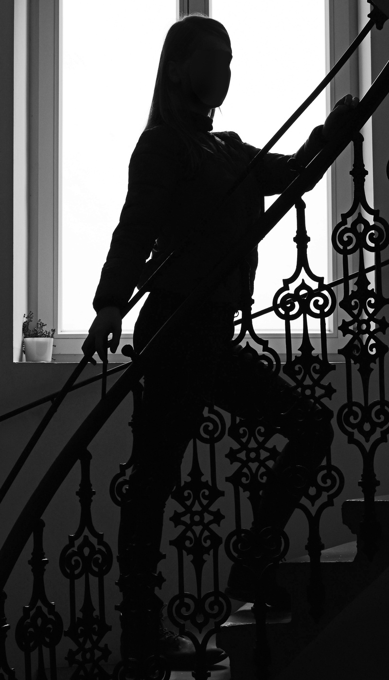 indoors, real people, building, wrought iron, back light, day, pattern, treppengeländer, adult, built structure, profile, female, young, holding, full length
