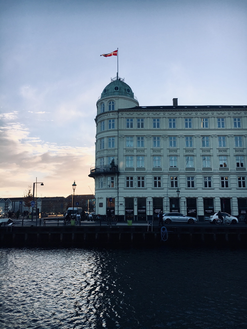 building, nautical vessel, 4K, canal, mode of transportation, flag, day, københavn, built structure, transportation, patriotism, sky, water, travel destinations