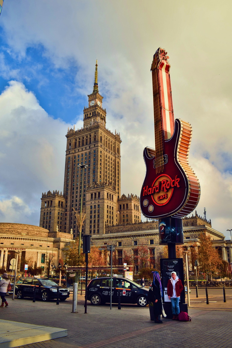 sign, outdoors, tall - high, tower, city, warsaw, land vehicle, road, real people, motor vehicle, mode of transportation, realism, street, transportation