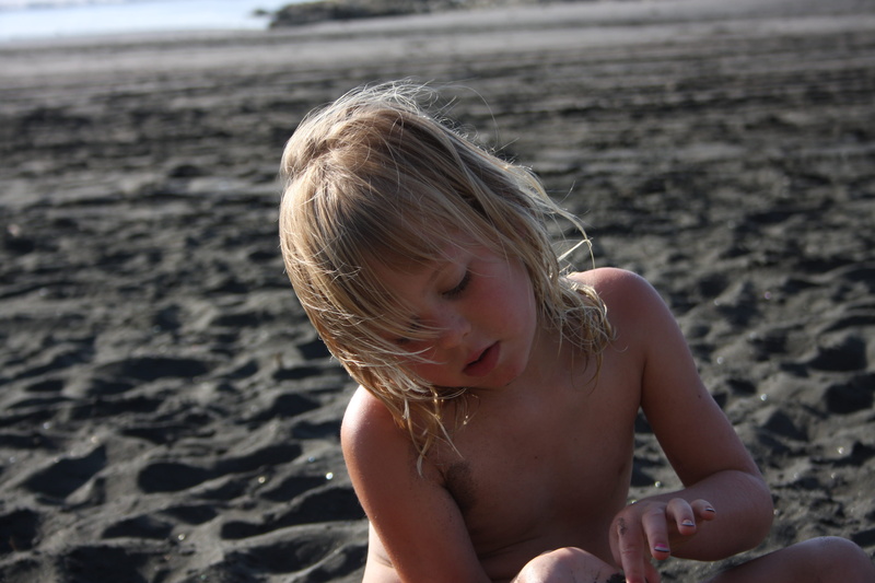 leisure activity, outdoors, child, blond hair, beach, real people, one person, sand, land, innocence, day, water, childhood, focus on foreground, hair