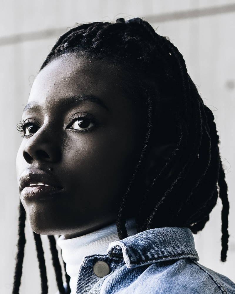2K, blue, woman, real people, braided hair, contemplation, one person, close-up, body part, lifestyles, person, black color, headscarf, staring, young adult