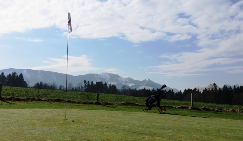 land, environment, hole, leisure activity, golf flag, sport, grass, patting, golf, activity, sky, field, beauty in nature, flag, mountain, outdoors, plant