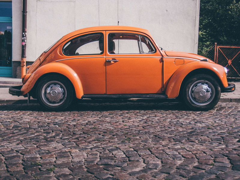 built structure, vw, volkswagen, vintage car, mode of transportation, wheel, land vehicle, motor vehicle, orange color, paving stone, transportation, oldtimer