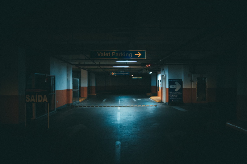 sign, empty, road, public transportation, transportation, no people, parking, diminishing perspective, western script, direction, built structure, light