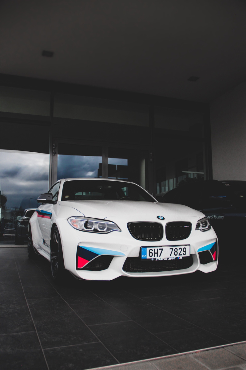 built structure, fast, garage, white, western script, toy, inside, no people, security, architecture, tire, alloy wheel, m2, vehicle, communication, wheel