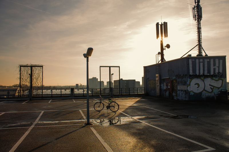 hispanic, sunset, shipping, outdoors, head, oil pump, clouds, cloud - sky, shadow play, sunlight, bicycle, graffiti, nature, built structure, bright, bike