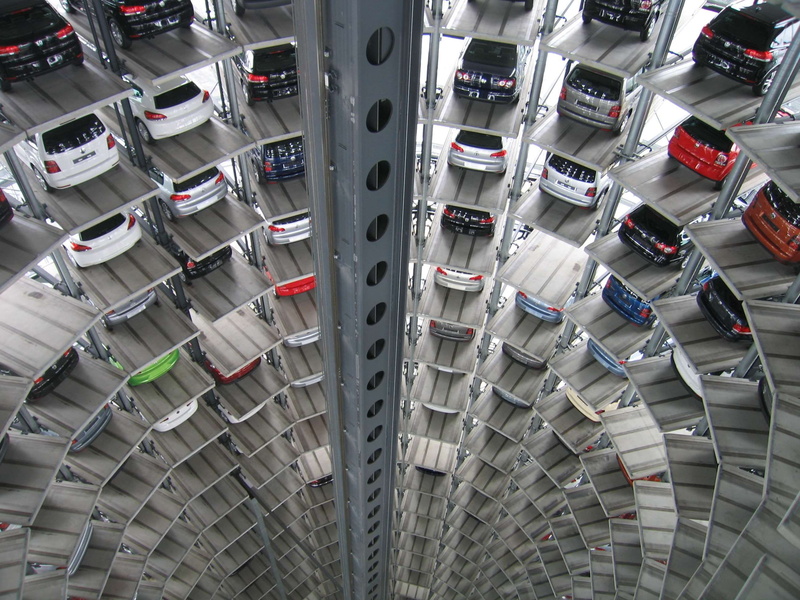 in a row, consumerism, parked cars, tower, built structure, abundance, garage, indoors, transportation, car, order, arrangement, automobile, high angle view