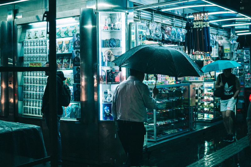 night, shopping, production, real people, men, illuminated, women, 5K, evening, sidewalk, along, wet, raining, built structure, retail, light, store, urban
