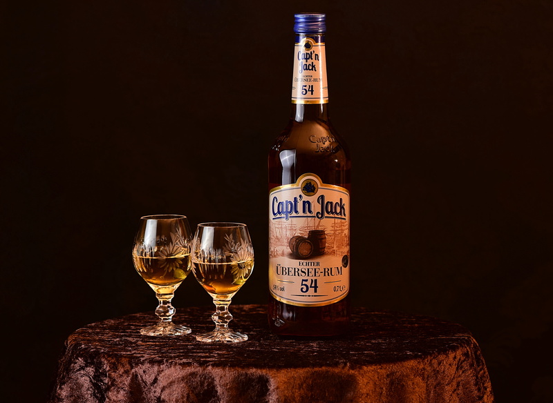 refreshment, container, rum, label, drink, alcohol, glasses, black background, wood - material, glass, indoors, after work, still life, bottle, mood, no people