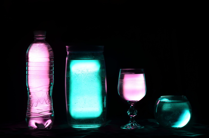 no people, bottle, luminous, 4K, copy space, pink color, glass - material, liquid, black background, transparent, dark, water, purple, light-graphic, side by side
