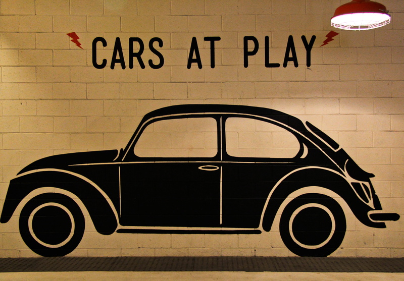 communication, car, sign, vehicle, hot rod, information sign, coupe, built structure, wall - building feature, message, sedan, hubcap, alloy wheel, car wheel