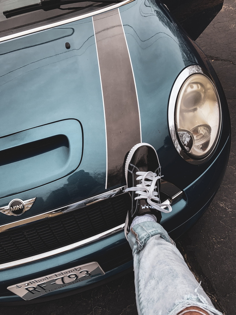headlight, human leg, motor vehicle, trademark, land vehicle, real people, car, travel, metal, outdoors, symbol, tire, hubcap, human, body part, high angle view