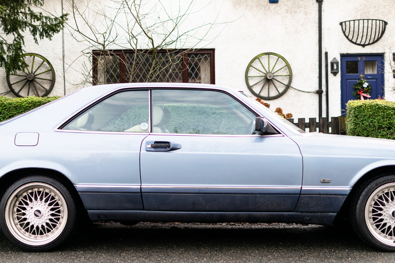 road, built structure, clutch wheel, spoke, building exterior, tire, 5K, parking, coupe, person, street, vehicle, mode of transportation, bike, motor vehicle