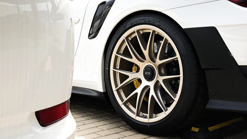 pattern, automobile, car wheel, cup, transportation, close-up, mode of transportation, wheel, machine, city, drink, car, land vehicle, wealth, architecture