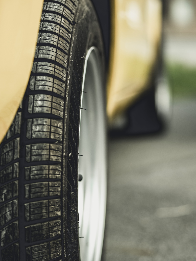 building, digital watch, hubcap, wheel, outdoors, vehicle, road, light, rubber, transportation, headlight, machine, mode of transportation, vehicle part