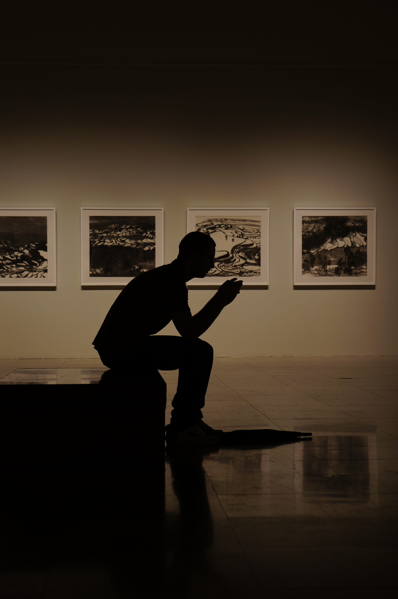 sitting, one person, holding, painting, architecture, reflection, flooring, photography, adult, leisure activity, man, home interior, music, recreation