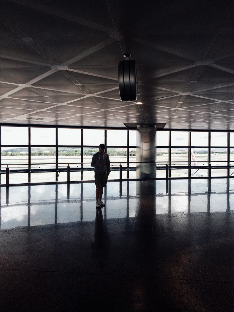 inside, ceiling, real people, walking, dark room, indoors, men, full length, inside Of, lifestyles, airport, window, flooring, modern, establishment, building