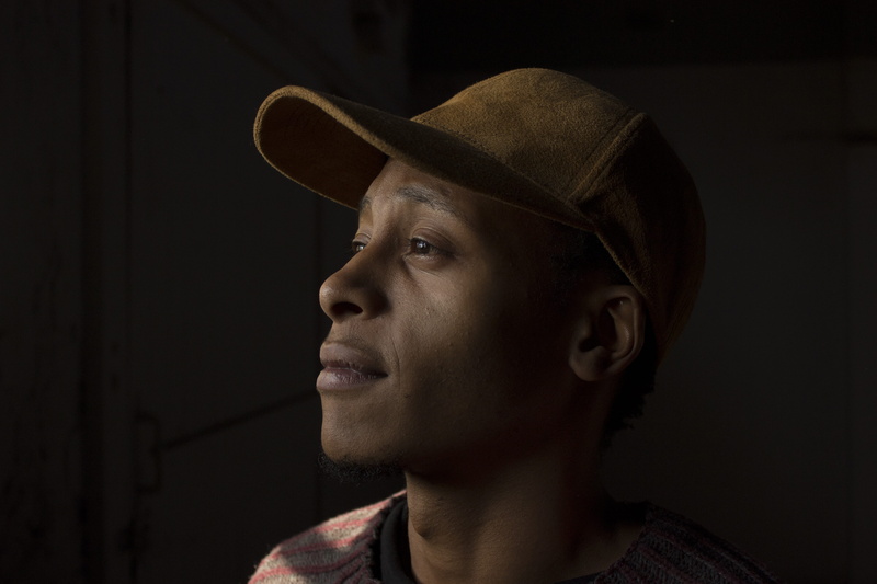 fashion, young adult, dark, adult, shirt, looking away, right, black, cap, indoors, male, style, light, headshot, human face, clothing, red, black skin