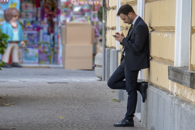 clothing, standing, business, suit, phone, leaning, side view, adult, italy, music, architecture, day, shoe, using phone, young adult, casual, footpath