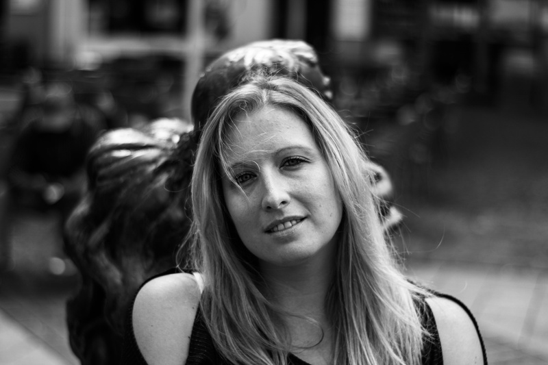 day, focus on foreground, front view, looking, lifestyles, young adult, one person, real people, outdoors, blond, road, bnw, contemplation, portrait, black and white