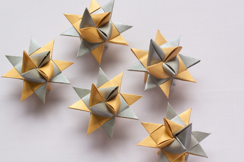 studio shot, shape, white background, star shape, gray, art and craft, high angle view, star, design, indoors, gold colored, origami, group of objects