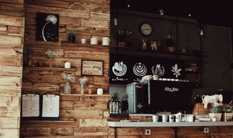 food and drink, furniture, coffee machine, wood - material, shelf, rack, day, decorations, variation, figurines, business, table, clock, large group of objects