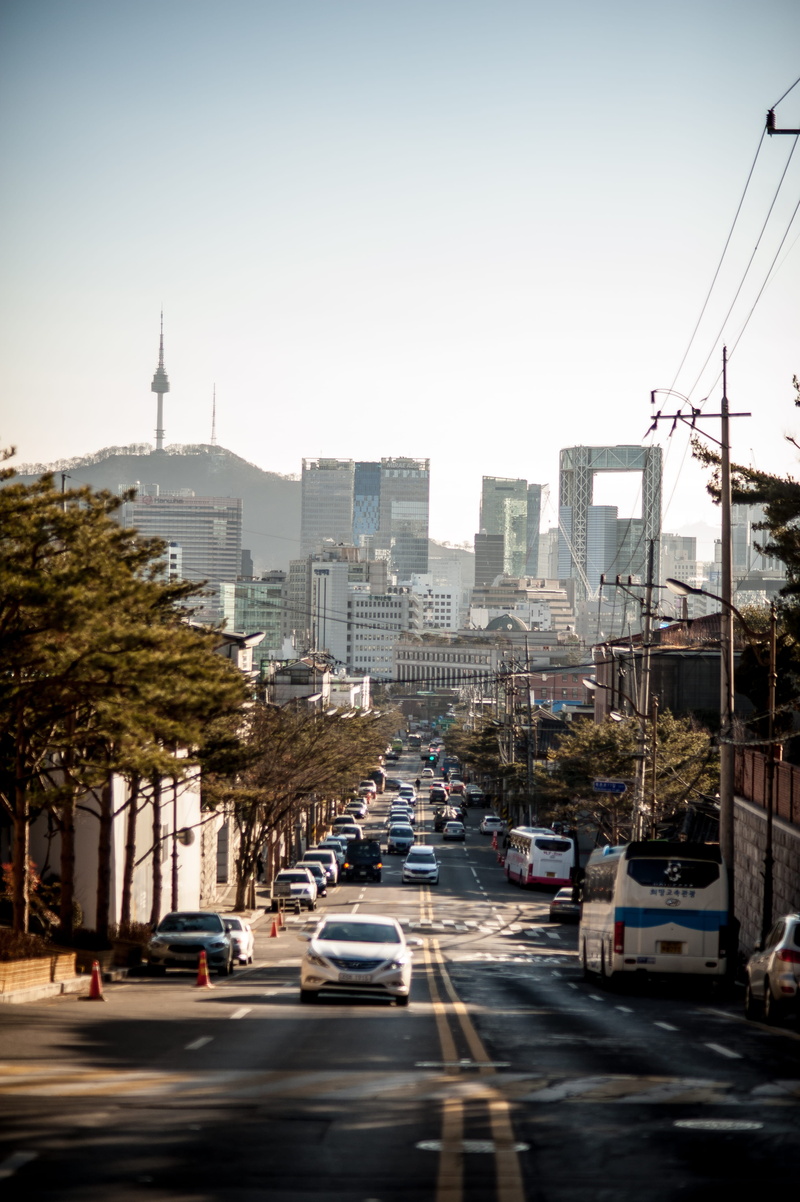 built structure, nature, city life, outdoors, traffic, city, road, sky, busy, korea, building, street, seoul, tree, motor vehicle, tower, land vehicle
