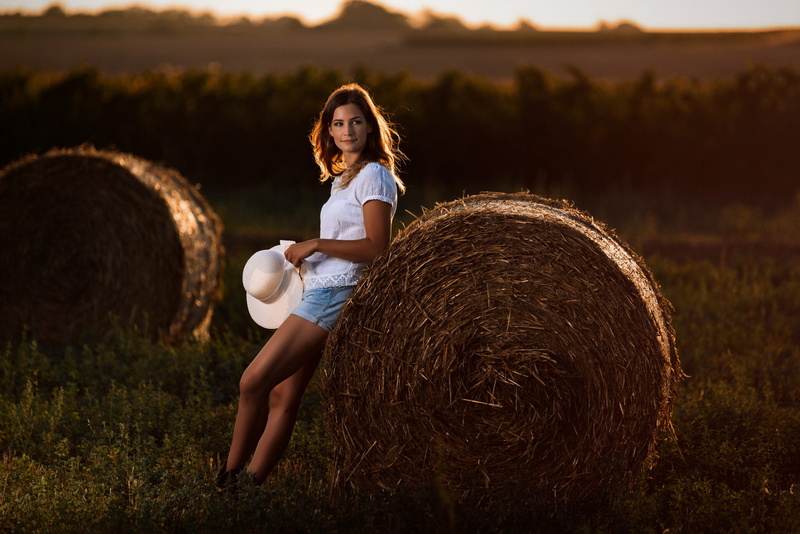 teenager, land, plant, sun hats, field, jean shorts, bale, nature, leisure activity, smiling, young adult, white shirt, landscape, brunette, lifestyles