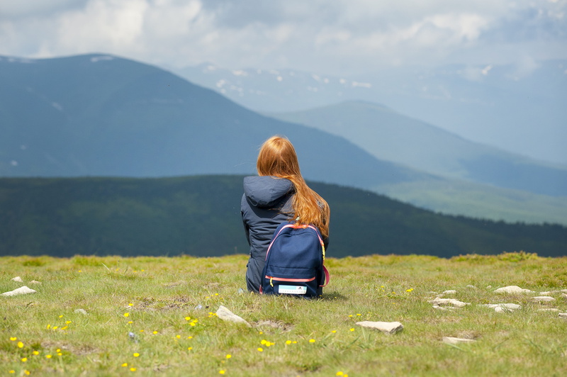 adult, outdoors, hooded, wear, grassy, sitting, field, rear view, idyllic, stones, landscape, mountain range, one person, 4K, women, scenics - nature