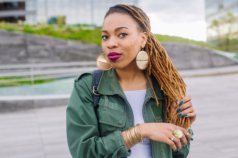 posing, photoshoot, young adult, black model, lady, standing, model, skin, young women, street, outdoor photography, focus on foreground, waist up, hair