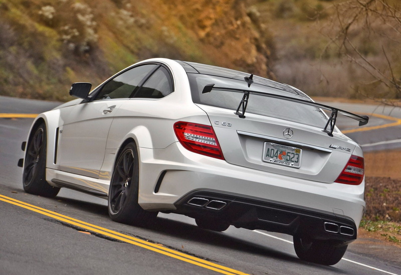 c63, motor vehicle, black, red, focus on foreground, on the move, mercedes-benz, outdoors, retro styled, land vehicle, motion, transportation, travel, car