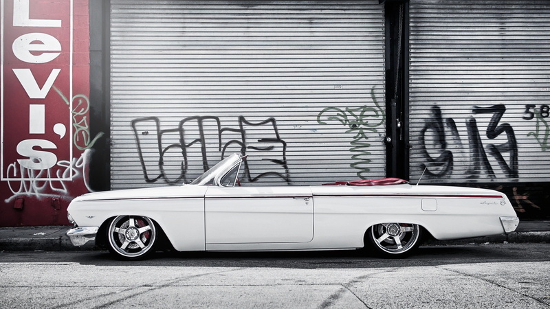 architecture, mode of transportation, communication, building, garage, metal, motor vehicle, day, parking, white cars, vehicle, transportation, Chevy, city