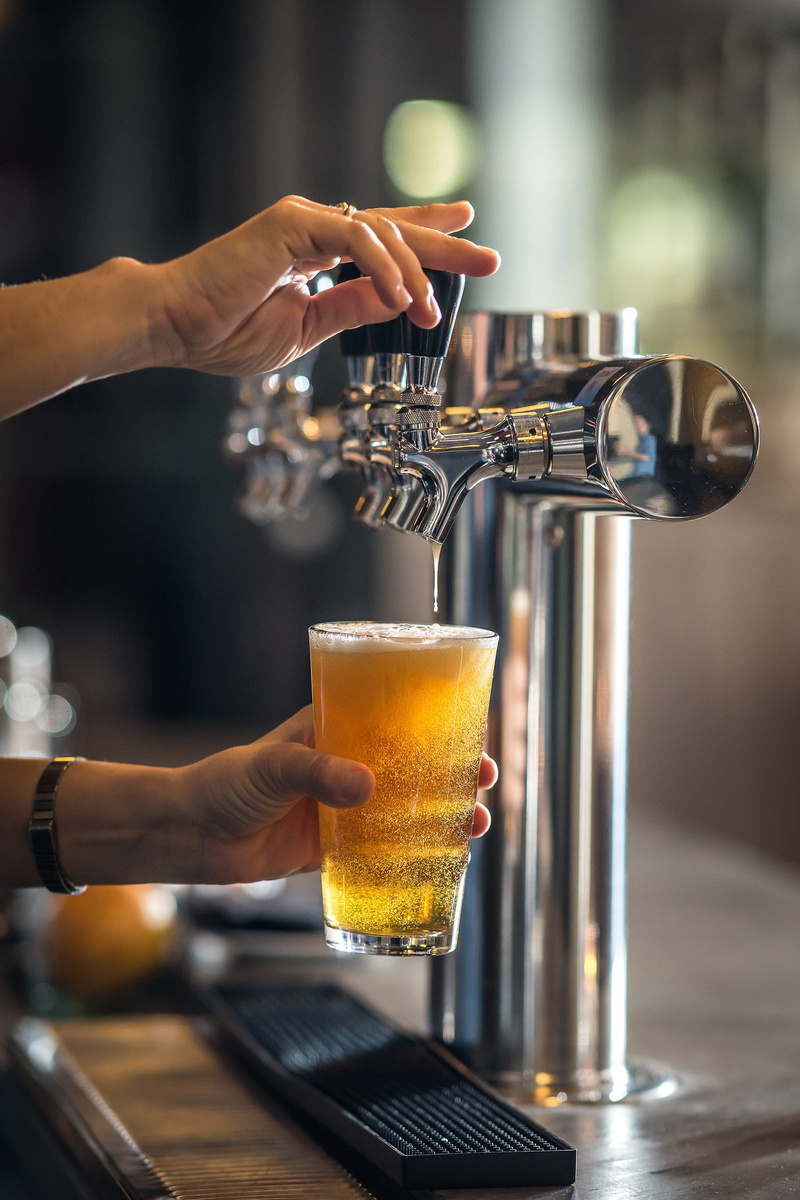 food and drink, indoors, beverage, beer, holding, coffee shop, hand, real people, pub, refreshment, bar counter, coffee - drink, bar - drink establishment
