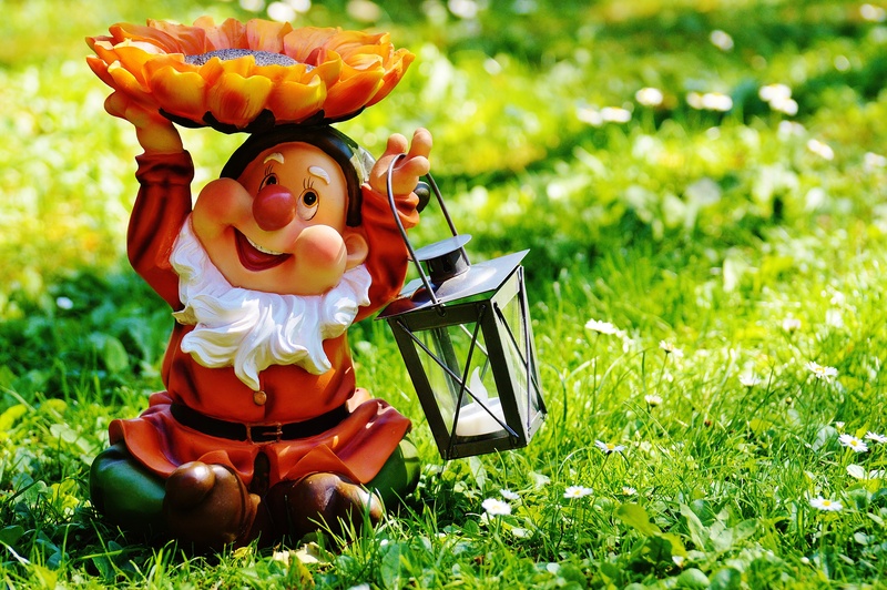 lantern, dwarf, one person, day, nature, green color, innocence, plant, clothing, orange, funny, focus on foreground, grass, sweet, land, healthy eating