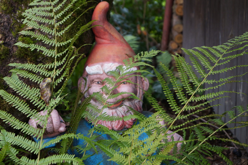 one person, outdoors, leaf, garden gnome, nature, body part, hand, tree, 4K, plant part, human body part, decoration, day, green color, finger, plant