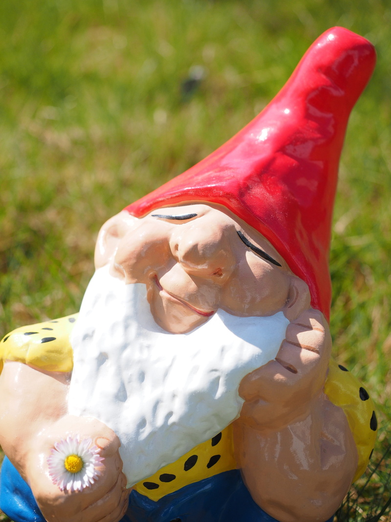 one woman only, nature, happy, funny, dreamy, childhood, day, holding, child, Dwarf, focus on foreground, close-up, red, stone figure, people, garden figurines